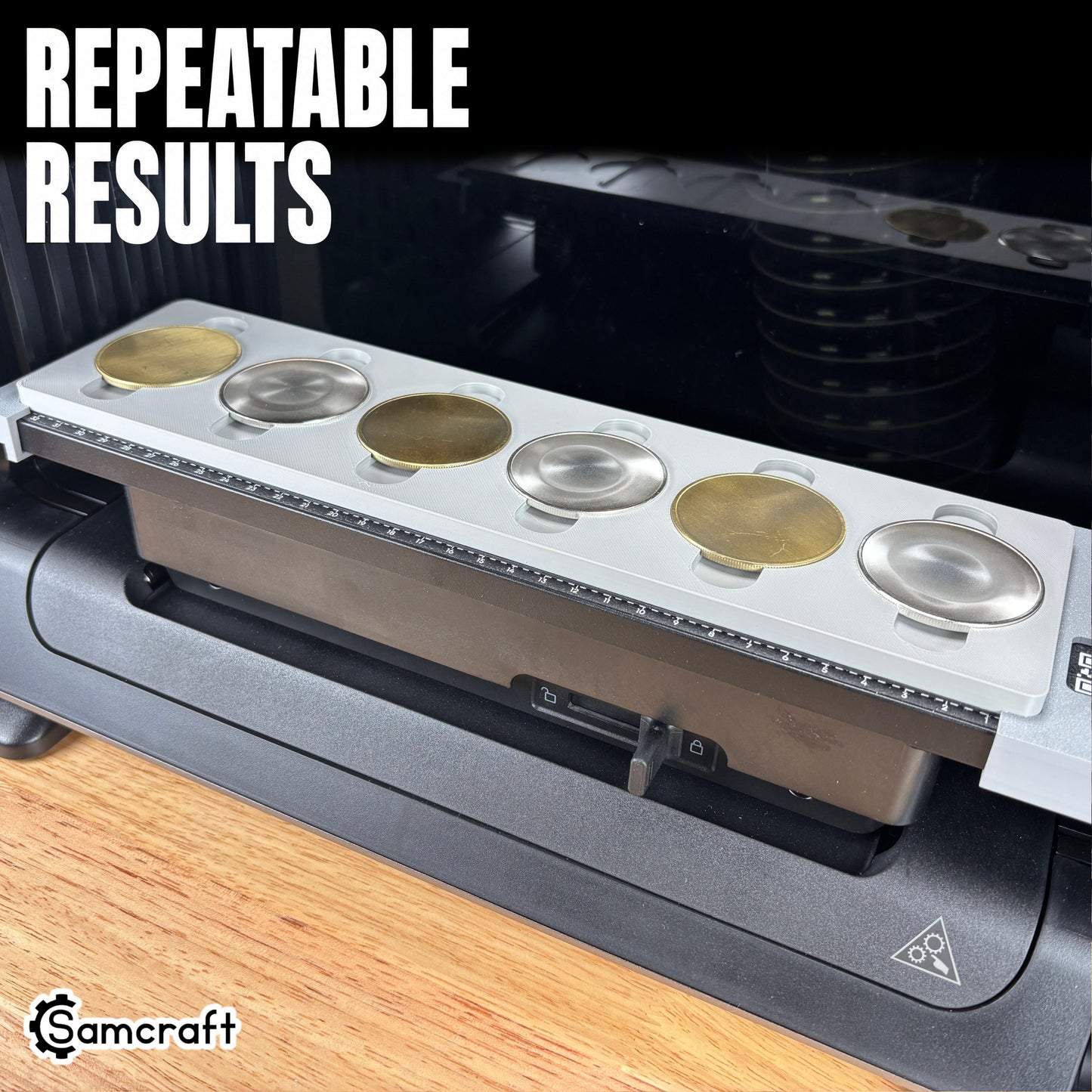 Gold and silver metal coin blanks seated evenly in the Samcraft Metal Coin Jig's recesses, demonstrating repeatable results and the alignment ruler on the eufyMake E1.