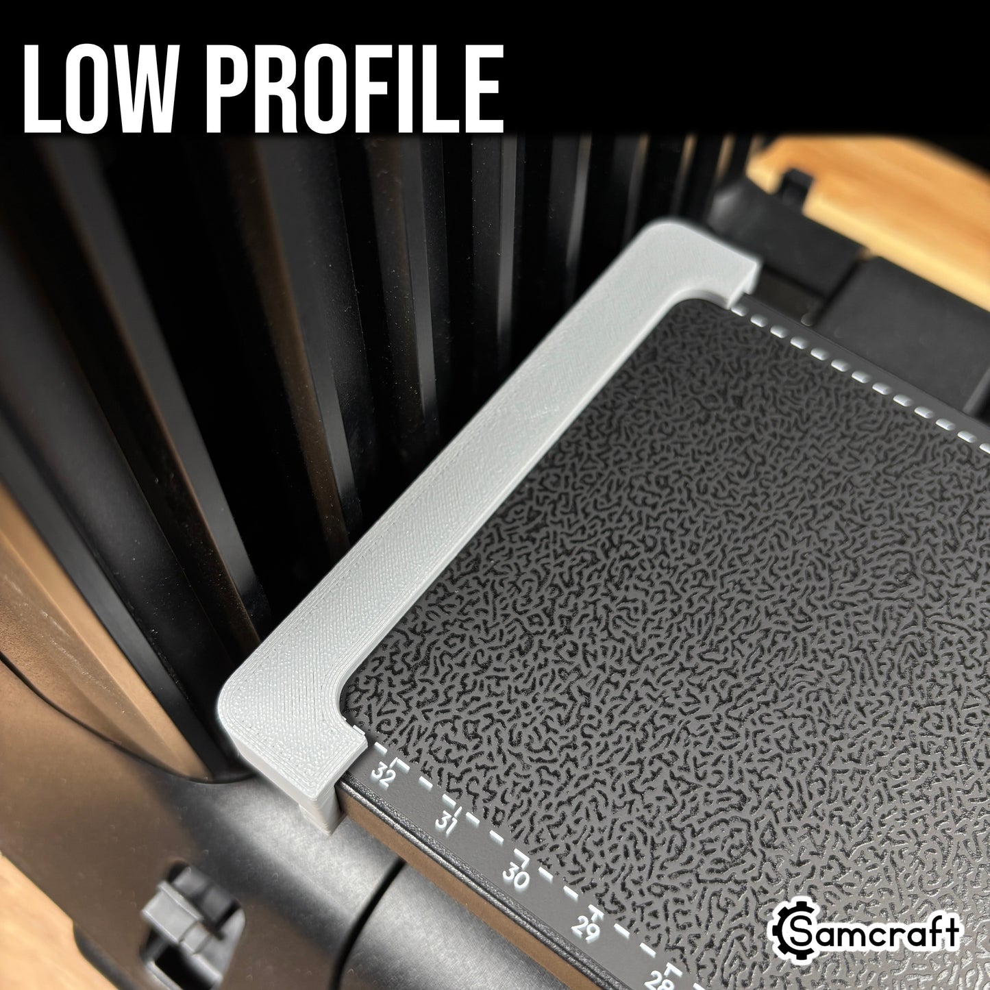 Jig Alignment System for the eufyMake E1 — close-up of the slim gray 3D-printed alignment rail seated along the edge of the printer's black textured bed next to the built-in ruler, showing its low profile.