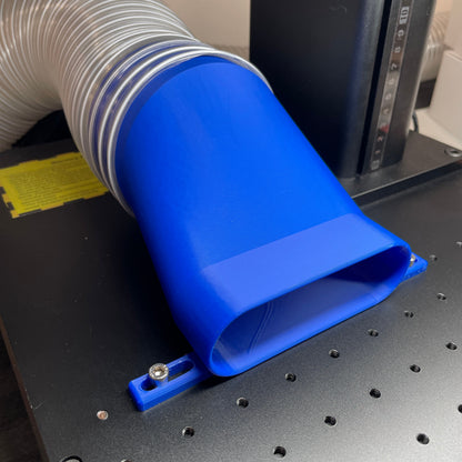 Samcraft 4 inch low profile fume extractor in blue, fitted to a ComMarker galvo laser with a silver flexible duct attached.