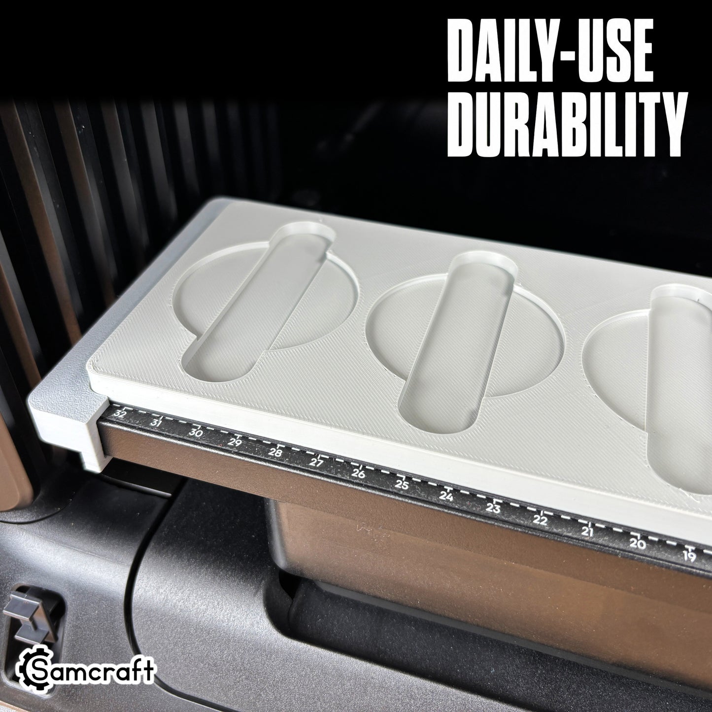 Close-up of the durable Samcraft Metal Coin Jig's empty gray recessed cradles with finger-relief cutouts and built-in alignment ruler on the eufyMake E1.