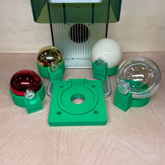 Samcraft green ball ornament jig with its base plate and size-marked holders, seating red, gold, cream and clear ball ornaments.