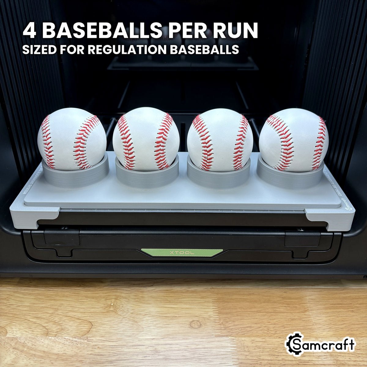Samcraft jig for the xTool Omni loaded with four regulation baseballs, a full four-ball run in a single pass.