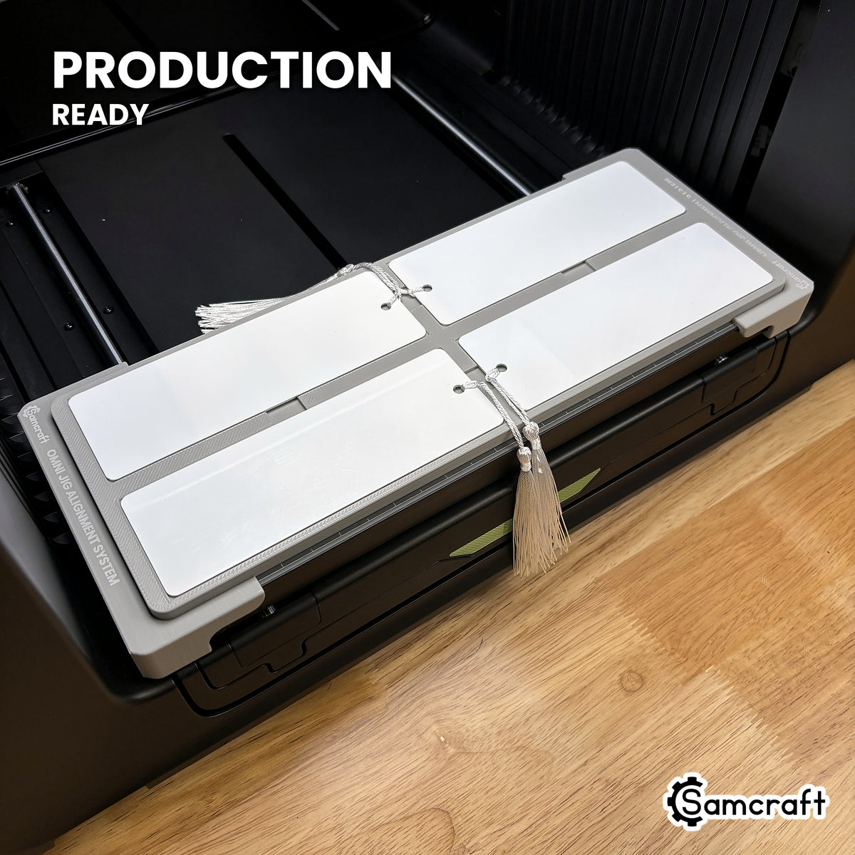 Samcraft bookmark jig loaded with four bookmarks on the xTool Omni UV printer bed, set up for production runs.
