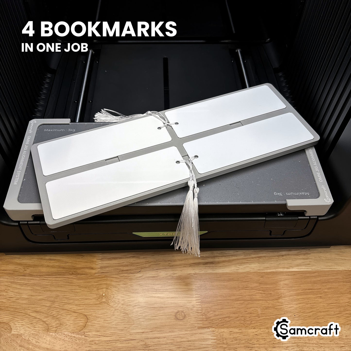 Four printed 2x6 bookmarks in the Samcraft xTool Omni jig, all four finished in a single job.