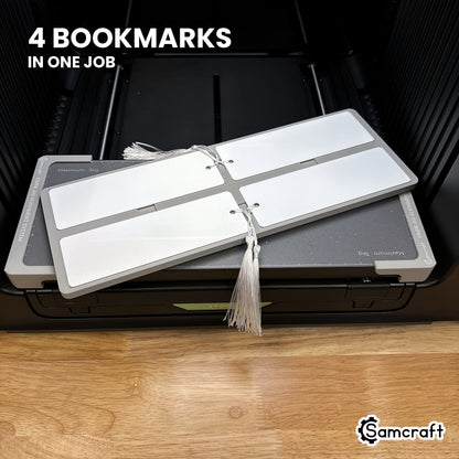 Four printed 2x6 bookmarks in the Samcraft xTool Omni jig, all four finished in a single job.