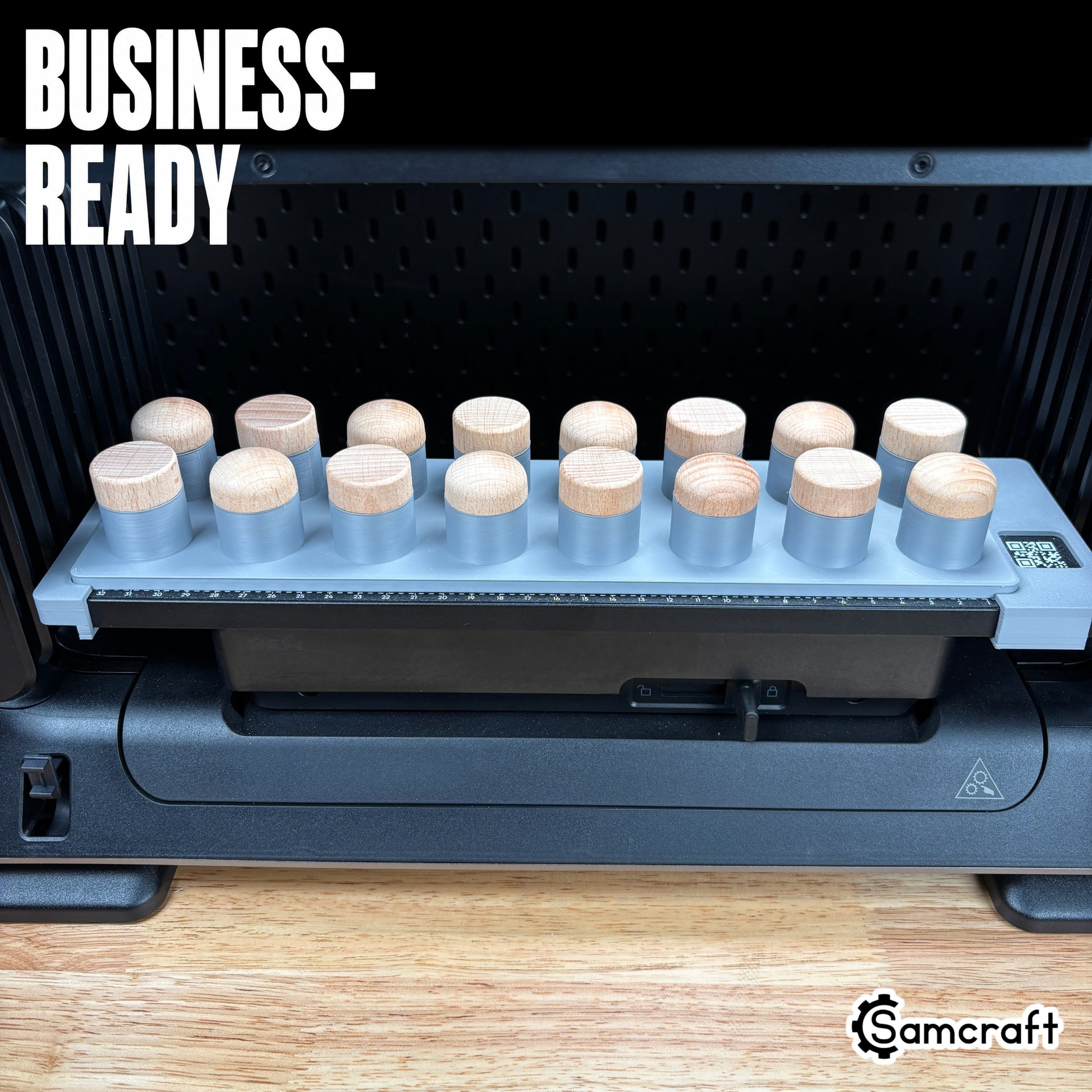 Business-ready Samcraft Bottle Stopper Jig holding two rows of wood-topped bottle stoppers in a gray tray with built-in ruler on the eufyMake E1 UV printer.