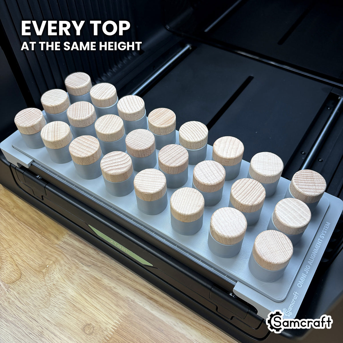 Wooden stopper tops held at matching height across the Samcraft xTool Omni jig for consistent print placement.