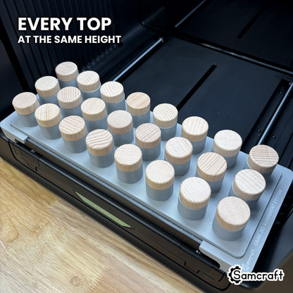 Wooden stopper tops held at matching height across the Samcraft xTool Omni jig for consistent print placement.