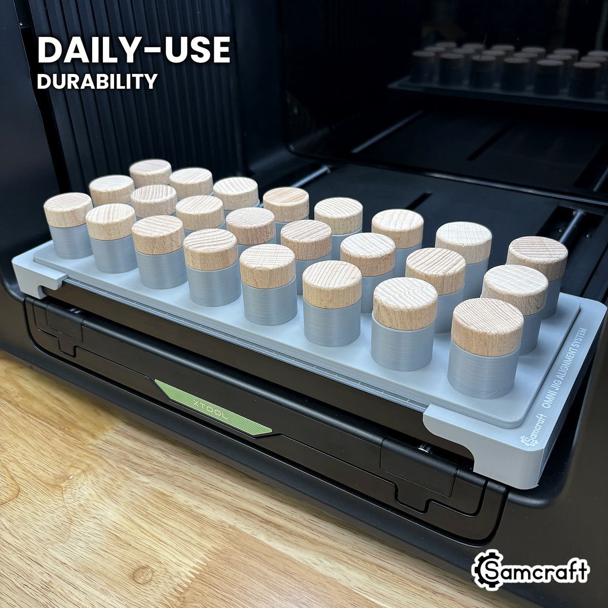 Samcraft bottle stopper jig in high-temperature rated plastic holding twenty-four stoppers on the xTool Omni bed, built for daily-use durability.