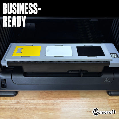 Samcraft Business Card Jig on the eufyMake E1 bed loaded with a yellow bottle-opener card, a white card and a black metal card