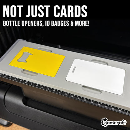 Samcraft Business Card Jig holding a yellow metal bottle-opener card and a white slotted ID badge card
