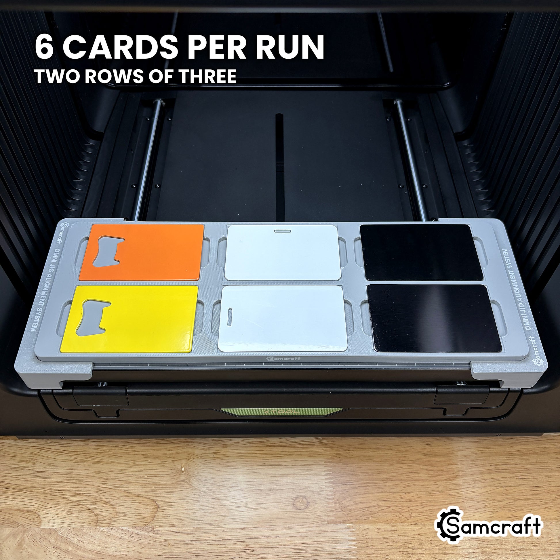 Samcraft card jig for the xTool Omni loaded with six card blanks, two rows of three, a full run in a single pass.