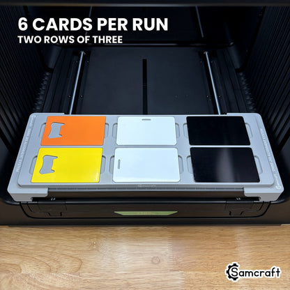 Samcraft card jig for the xTool Omni loaded with six card blanks, two rows of three, a full run in a single pass.