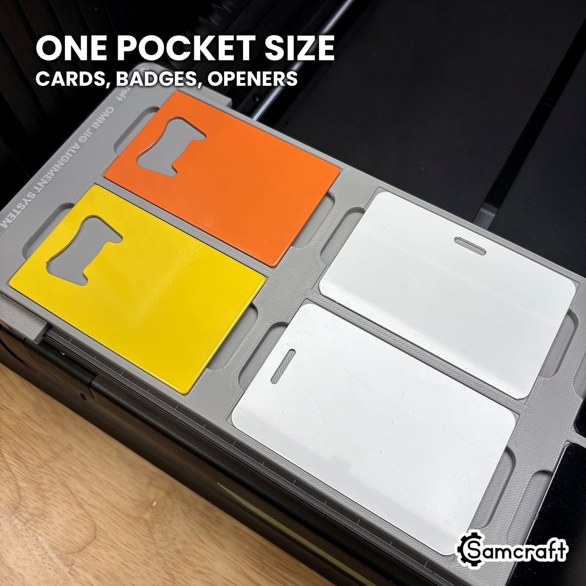 Close-up of the Samcraft xTool Omni card jig holding two card bottle openers and two PVC ID badges in identical CR80 pockets.