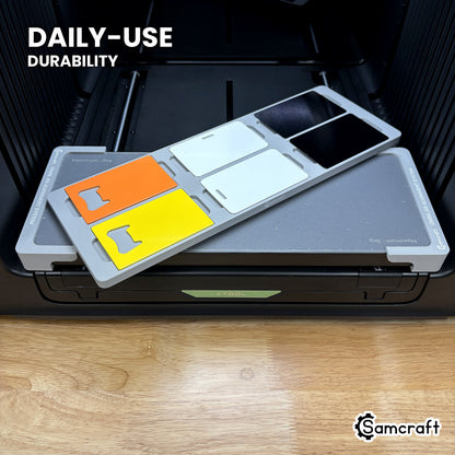 Samcraft card jig in high-temperature rated plastic holding six card blanks on the xTool Omni bed, built for daily-use durability.