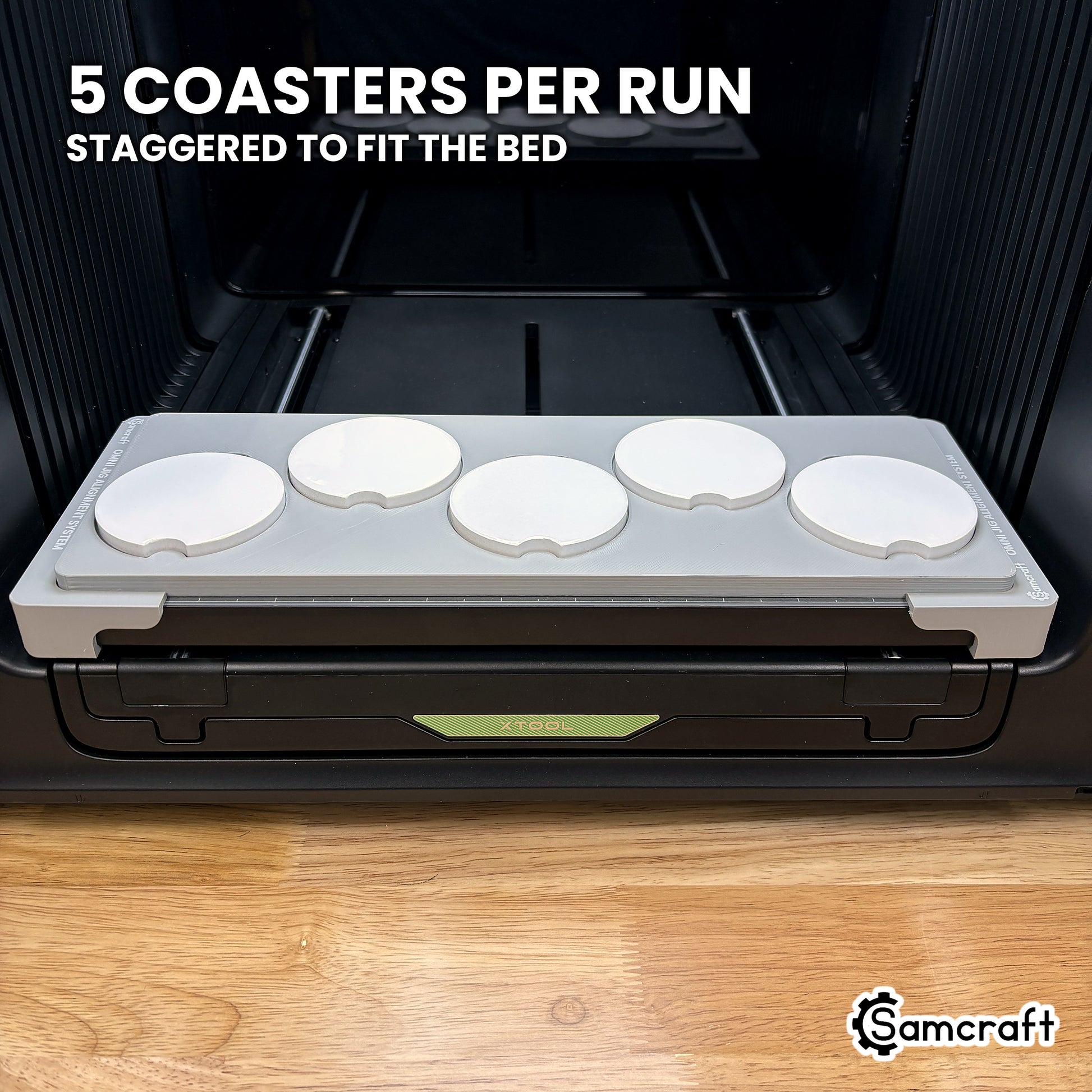 Samcraft car coaster jig for the xTool Omni loaded with five coasters, staggered to use the full bed width.