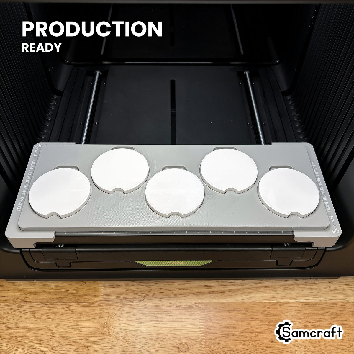Samcraft car coaster jig loaded with five coasters on the xTool Omni UV printer bed, set up for production runs.