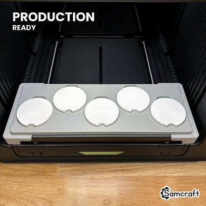 Samcraft car coaster jig loaded with five coasters on the xTool Omni UV printer bed, set up for production runs.