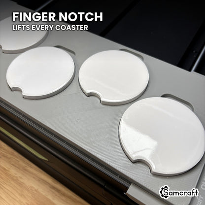 Close-up of the finger notch at a pocket of the Samcraft xTool Omni car coaster jig, for lifting a printed coaster out cleanly.