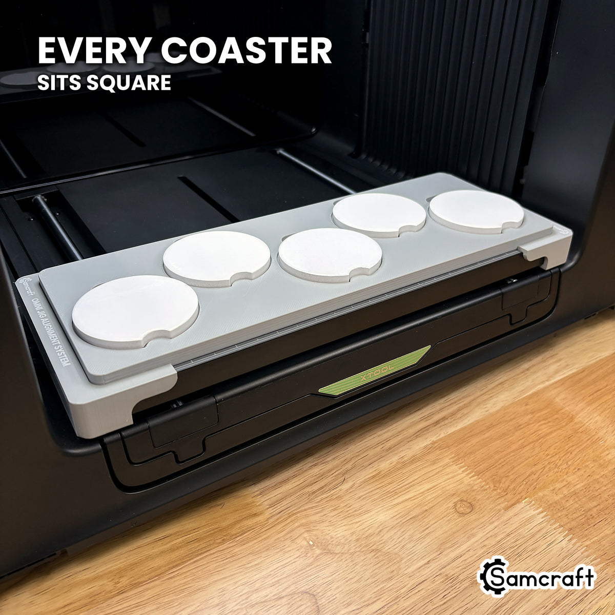 Every car coaster seated square in its own recess across the Samcraft xTool Omni jig, for consistent print placement.