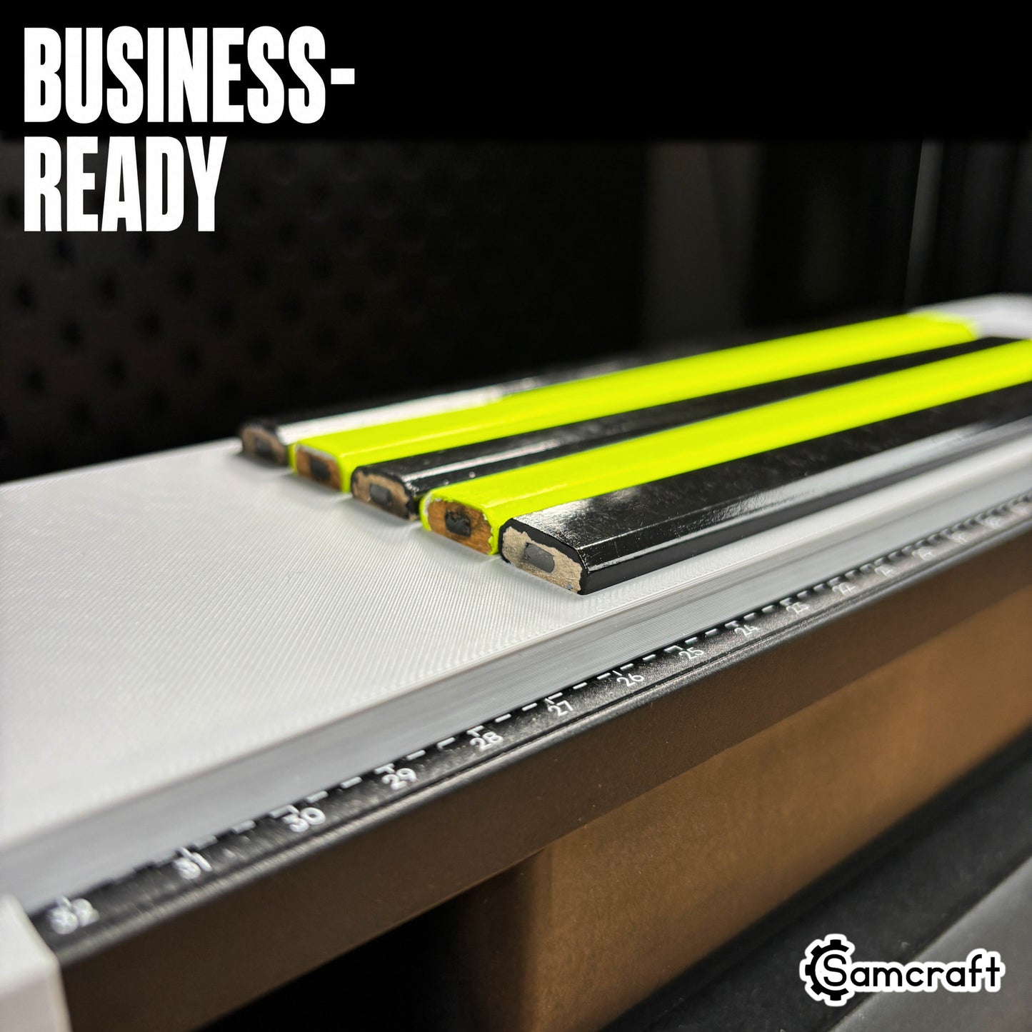 Detail shot of carpenter pencil tips lined up in the Samcraft jig's recessed channels on the eufyMake E1 print bed, showing consistent alignment for business production.