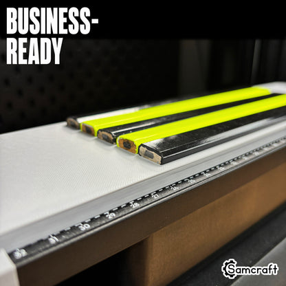 Detail shot of carpenter pencil tips lined up in the Samcraft jig's recessed channels on the eufyMake E1 print bed, showing consistent alignment for business production.
