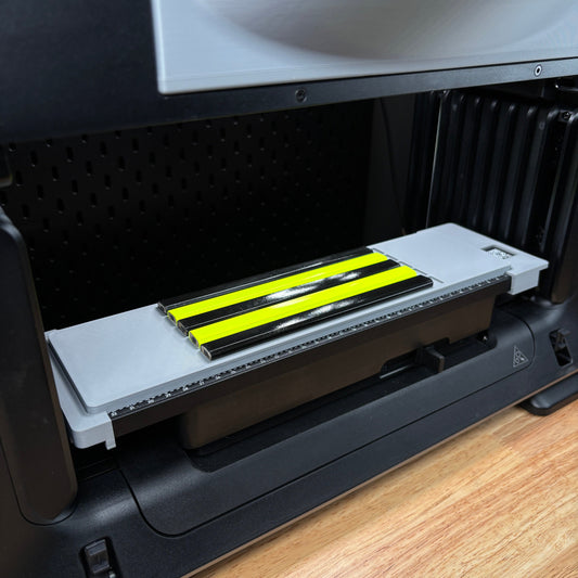 Samcraft carpenter pencil jig on the eufyMake E1 print bed, holding neon yellow carpenter pencils in long channels.