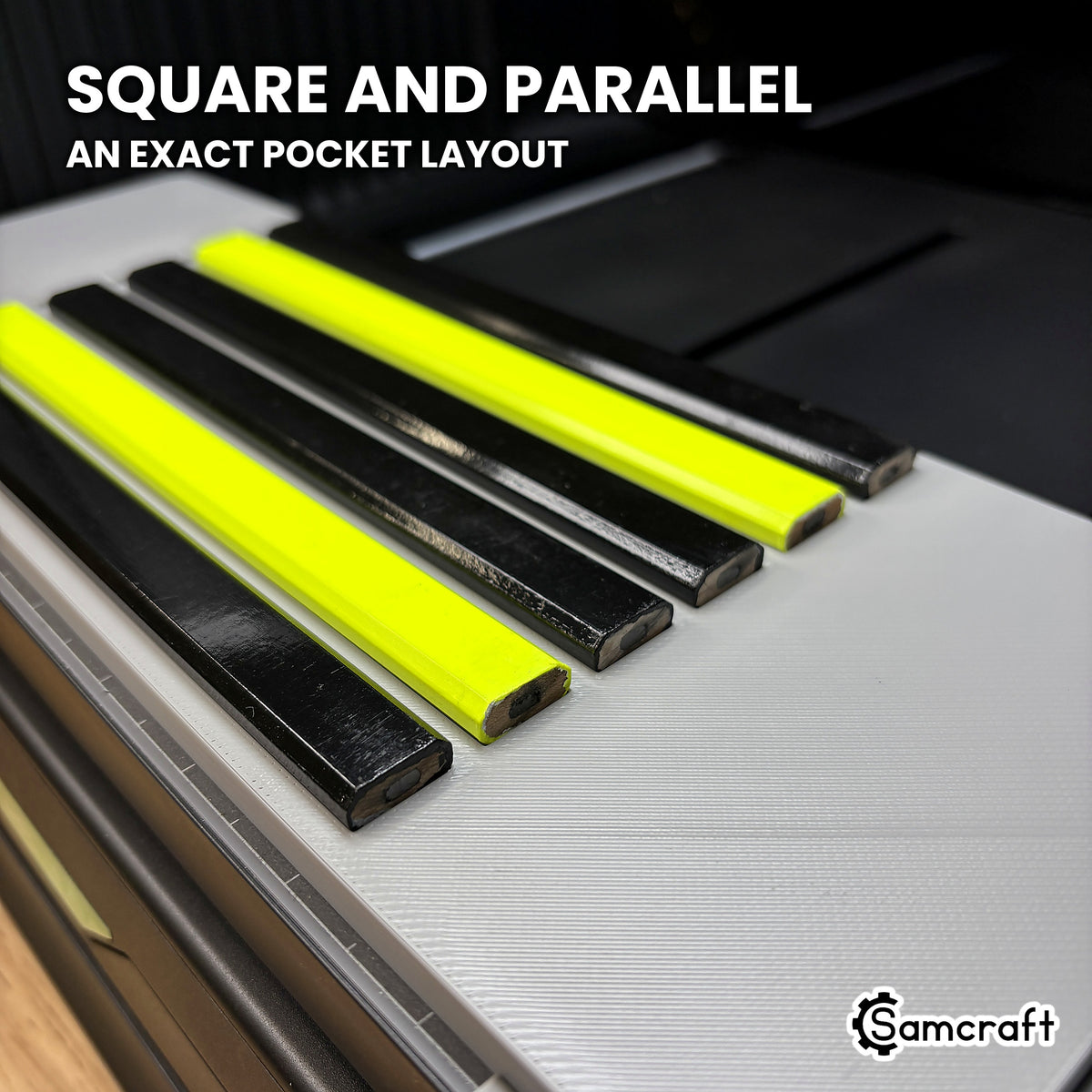 Low angle along six carpenter pencils lying square and parallel in the Samcraft xTool Omni jig, showing the even spacing of the pocket layout.