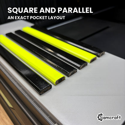 Low angle along six carpenter pencils lying square and parallel in the Samcraft xTool Omni jig, showing the even spacing of the pocket layout.
