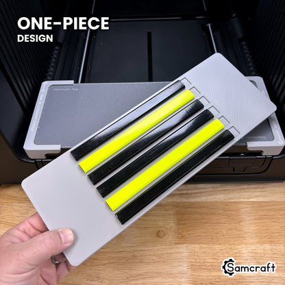 Hand holding the one-piece Samcraft carpenter pencil jig for the xTool Omni, a single molded gray tray loaded with six carpenter pencils.