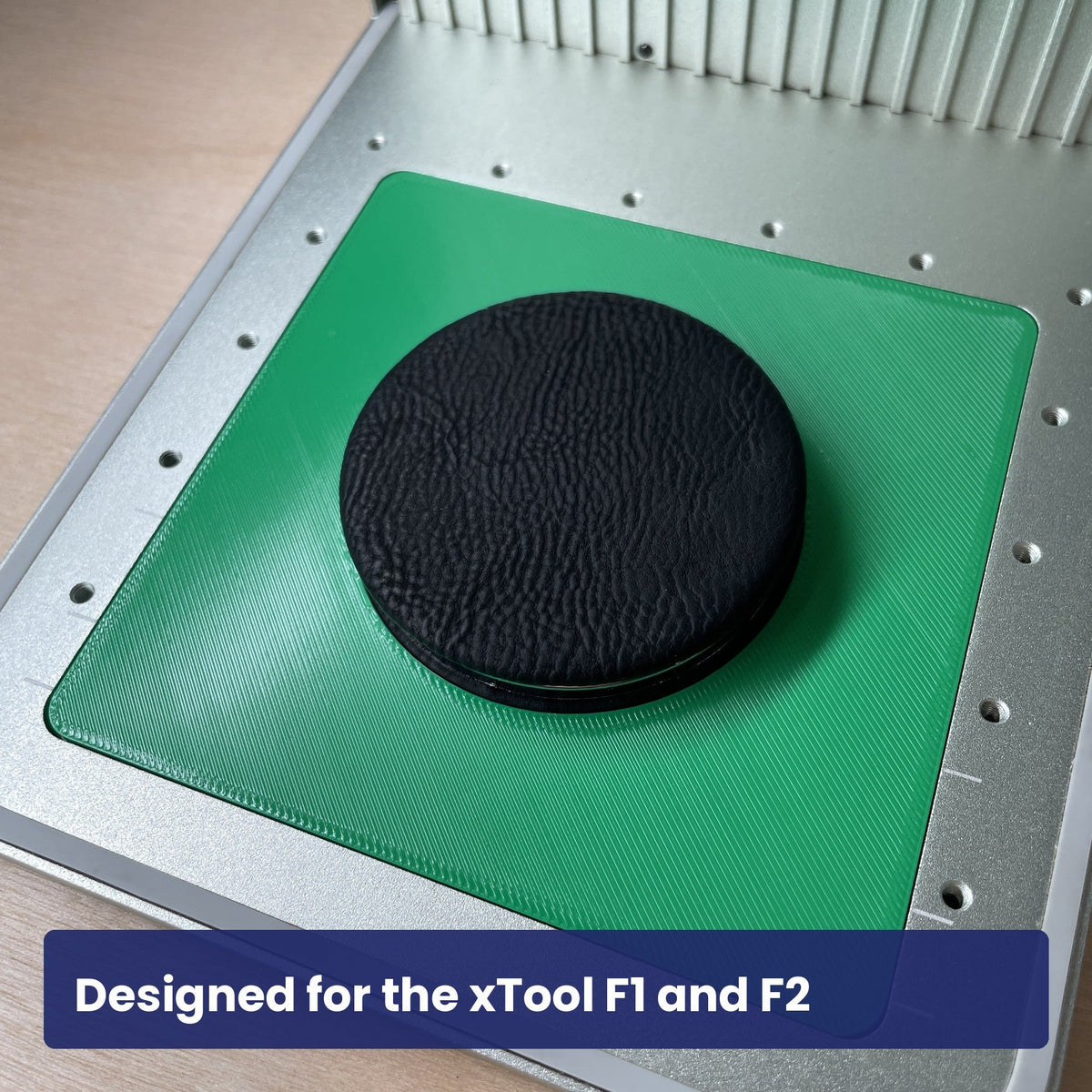 Samcraft compact mirror jig in the xTool F1 base plate with a black compact mirror seated in the circular recess.