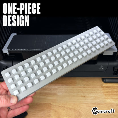 One-piece Samcraft 10mm Dice Jig held in hand above the eufyMake E1 print bed, fully loaded with dice