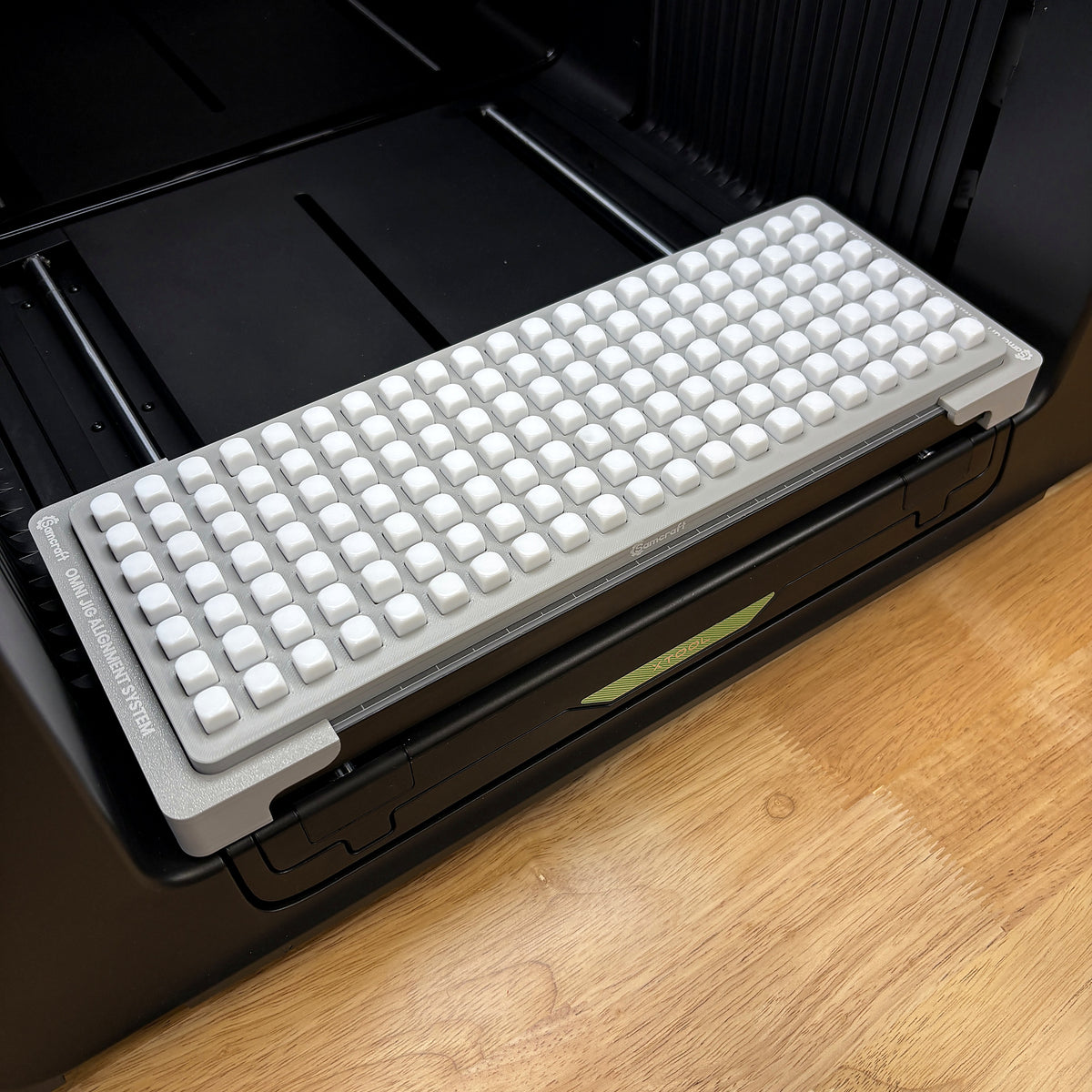 Samcraft 10mm dice jig on the bed of an xTool Omni UV printer, holding a full grid of 147 white blank dice.