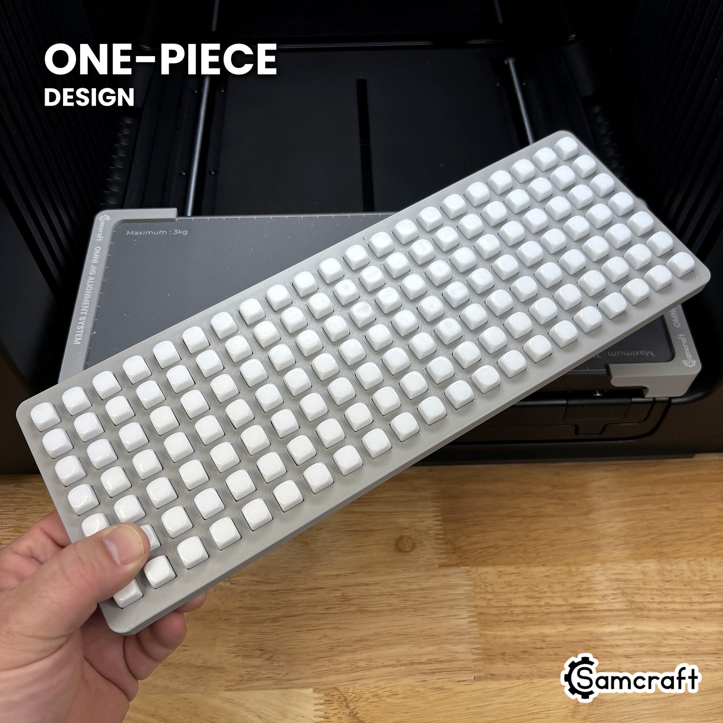 Hand holding the one-piece Samcraft 10mm dice jig for the xTool Omni, 147 blank dice seated in a single molded gray tray.