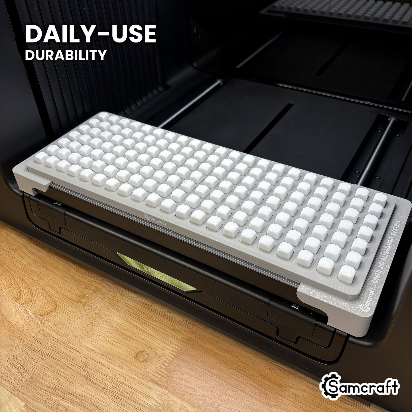 Samcraft 10mm dice jig in high-temperature rated plastic holding a full grid of blank dice on the xTool Omni bed, built for daily-use durability.