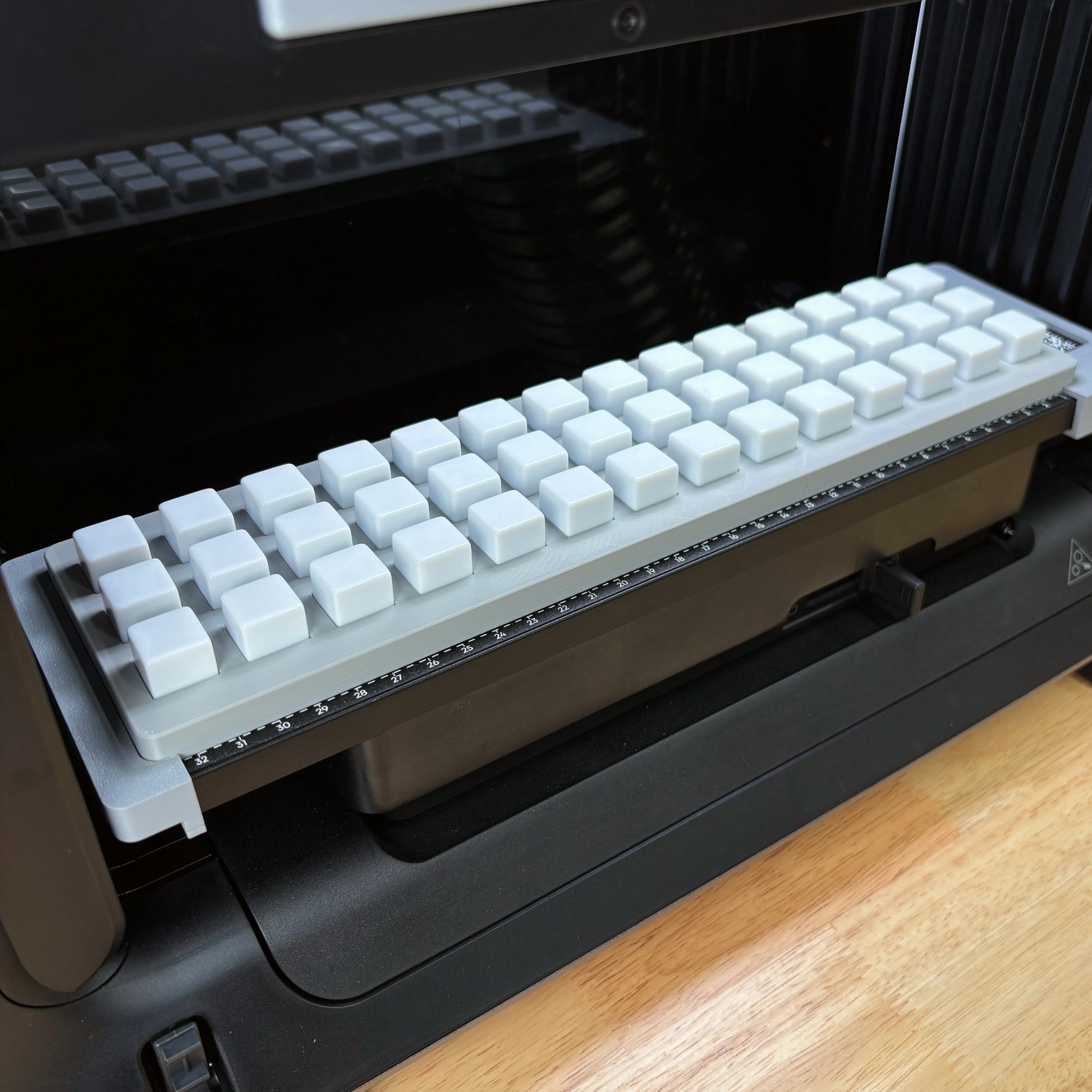 Samcraft 16mm Dice Jig fully loaded with white 16mm dice on the eufyMake E1 UV printer bed