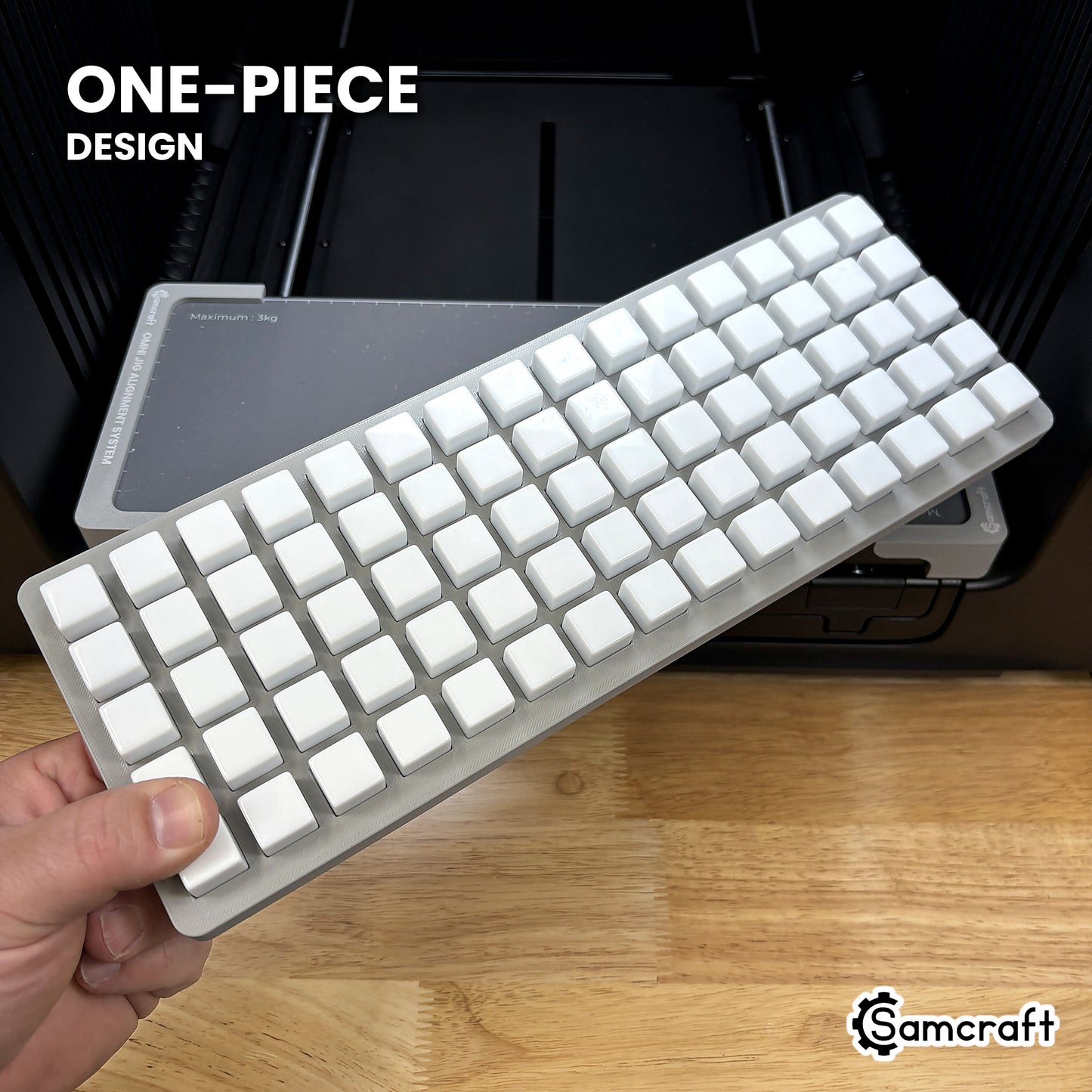 Hand holding the one-piece Samcraft 16mm dice jig for the xTool Omni, 75 blank dice seated in a single molded gray tray.