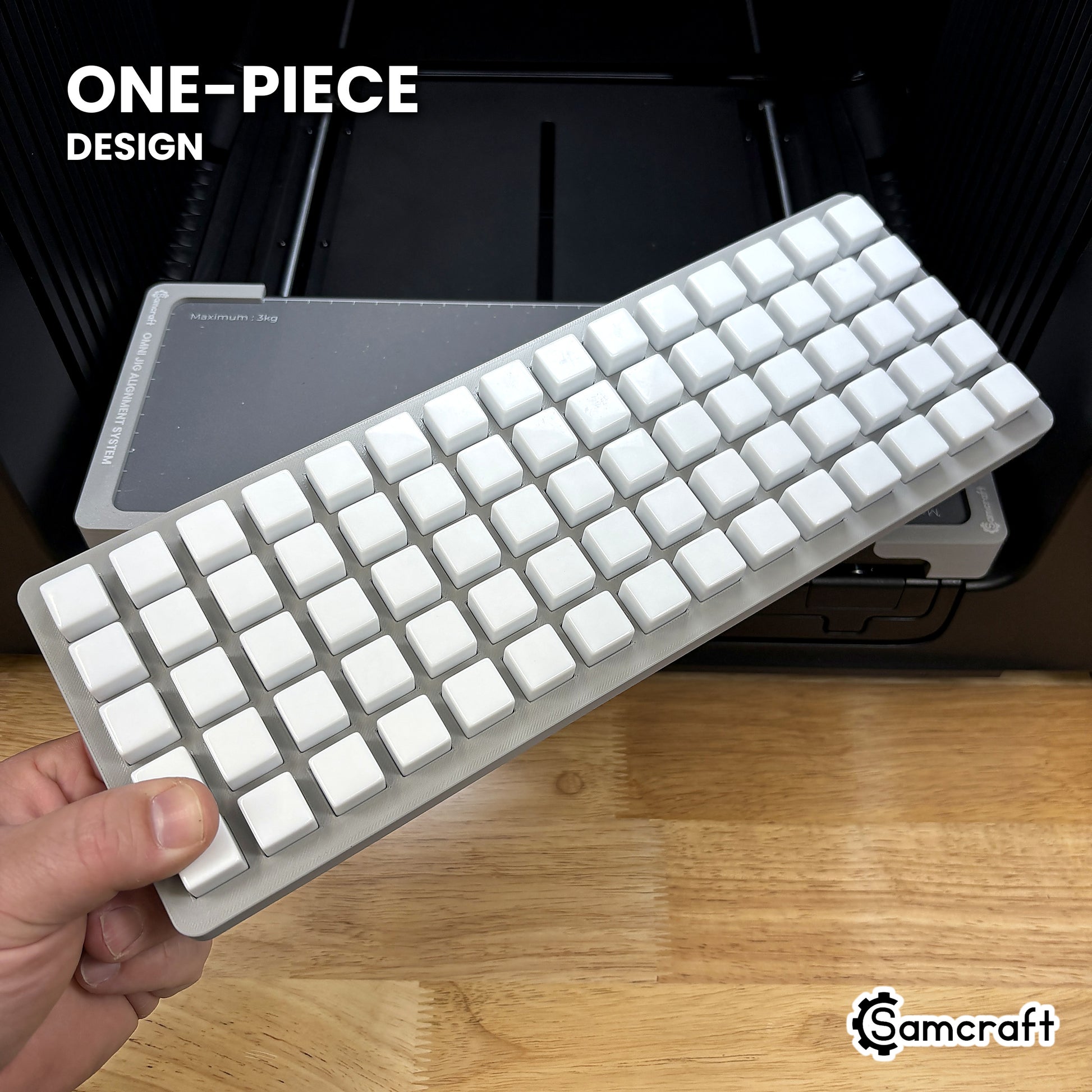 Hand holding the one-piece Samcraft 16mm dice jig for the xTool Omni, 75 blank dice seated in a single molded gray tray.