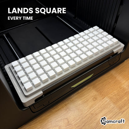 Samcraft 16mm dice jig seated square on the xTool Omni printer bed, every pocket aligned to the same orientation.