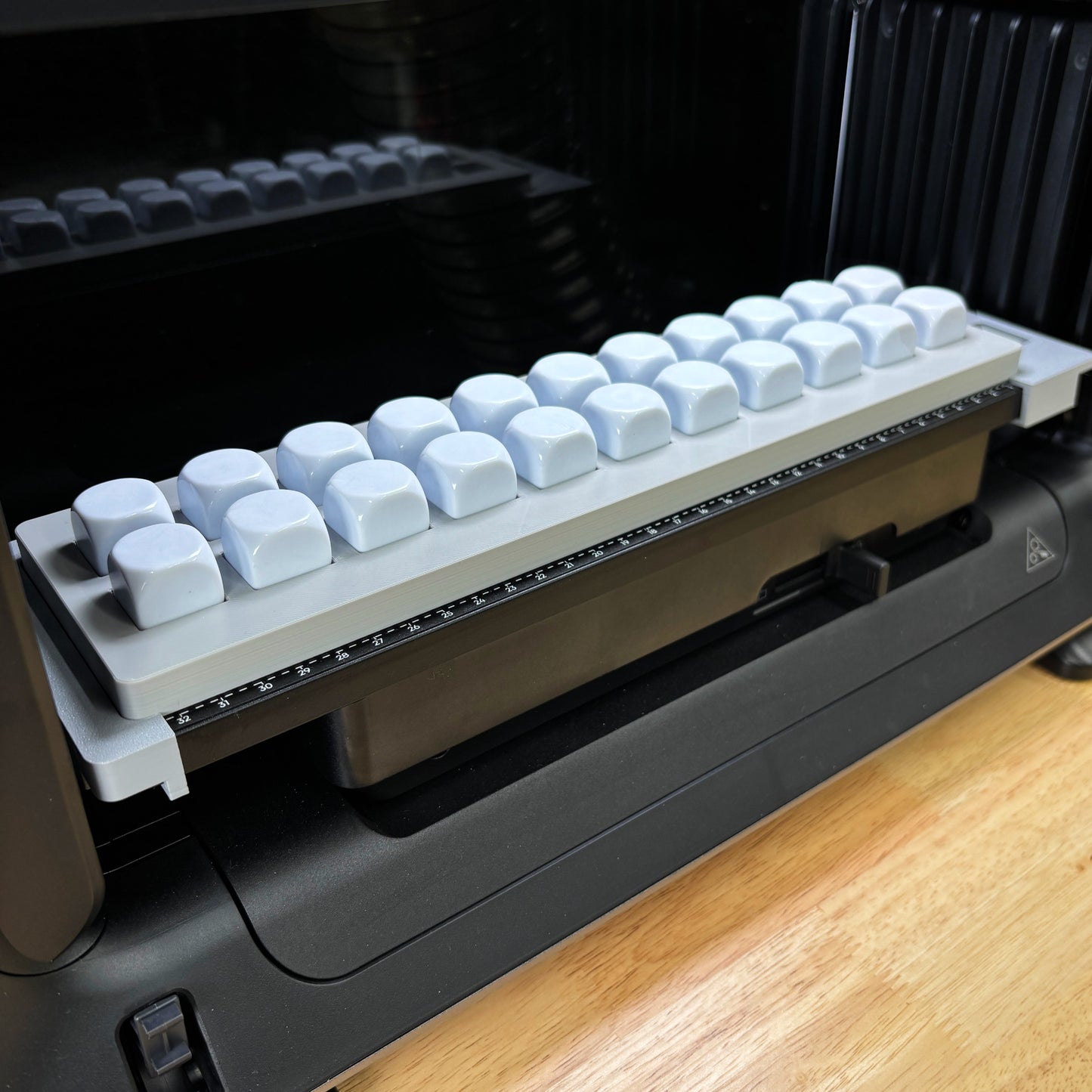 Samcraft 22mm Dice Jig loaded with white 22mm dice on the eufyMake E1 UV printer bed