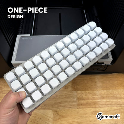 Hand holding the one-piece Samcraft 22mm dice jig for the xTool Omni, 48 blank dice seated in a single molded gray tray.