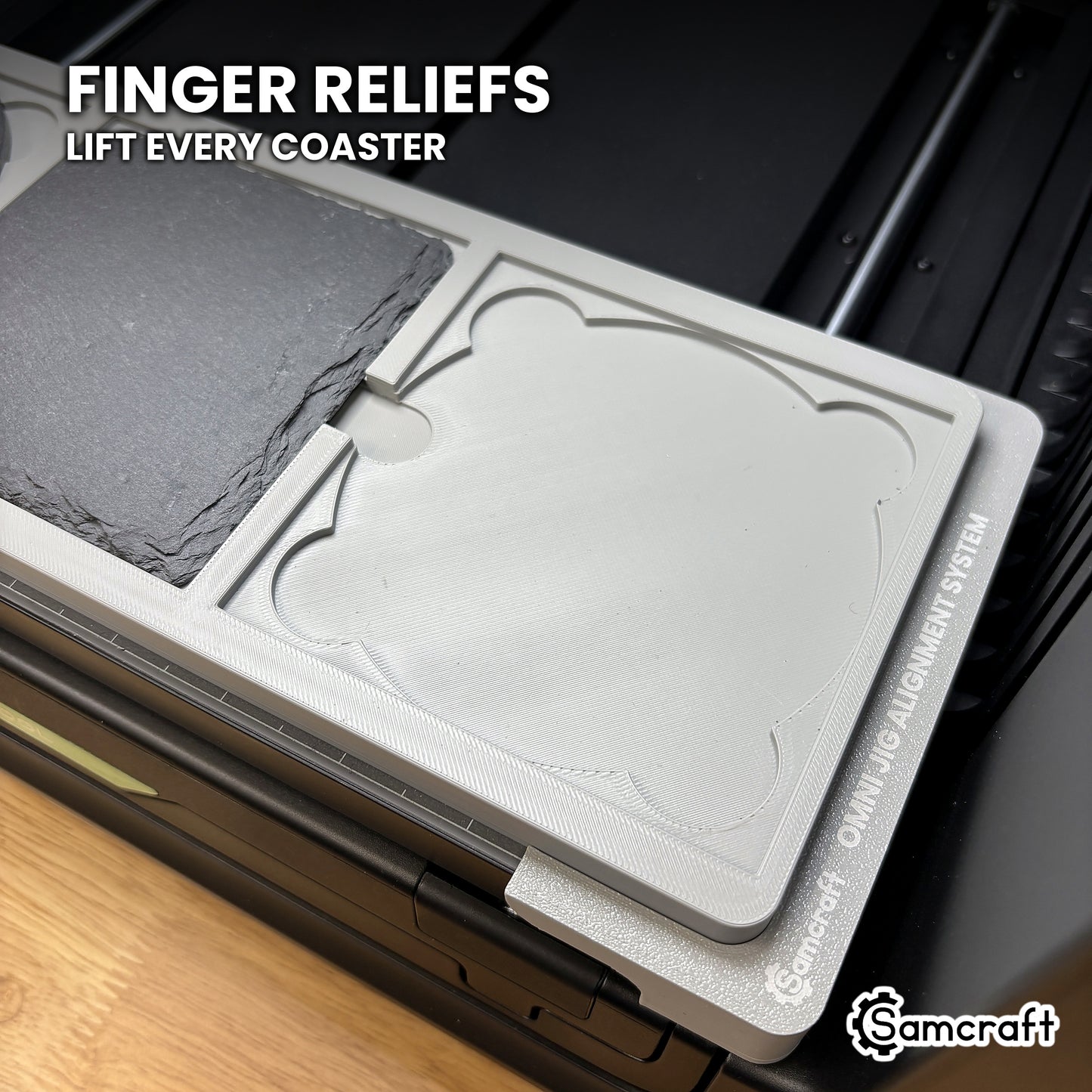Close-up of the finger reliefs at each pocket of the Samcraft xTool Omni coaster jig, for lifting a printed coaster out cleanly.