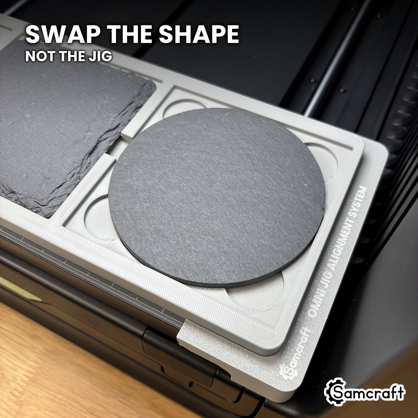 A round slate coaster seated in the same Samcraft xTool Omni pocket that takes a square coaster, showing the shape swaps without changing jigs.