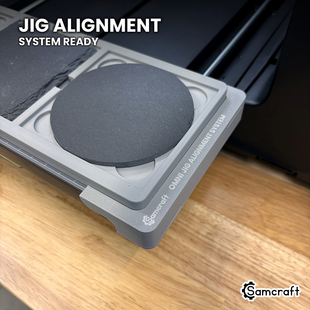 Samcraft 4 inch coaster jig seated on the optional Samcraft Omni Jig Alignment System, the alignment system lettering visible along the edge.