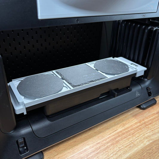 Samcraft 4 inch drink coaster jig on the eufyMake E1 print bed, holding round slate coasters.