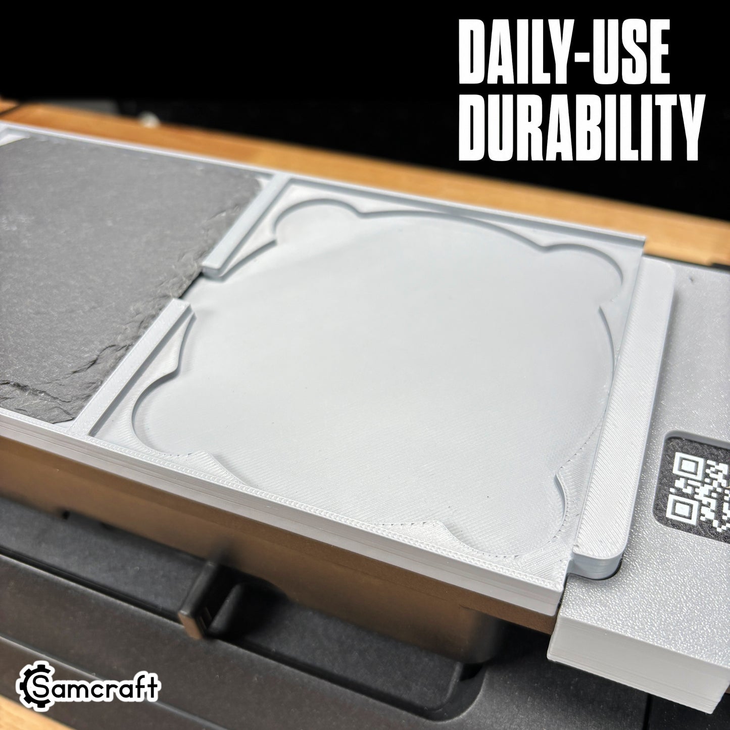 Close-up of the Samcraft 4-inch Drink Coaster Jig's durable gray tray with a recessed coaster pocket and built-in alignment ruler on the eufyMake E1.