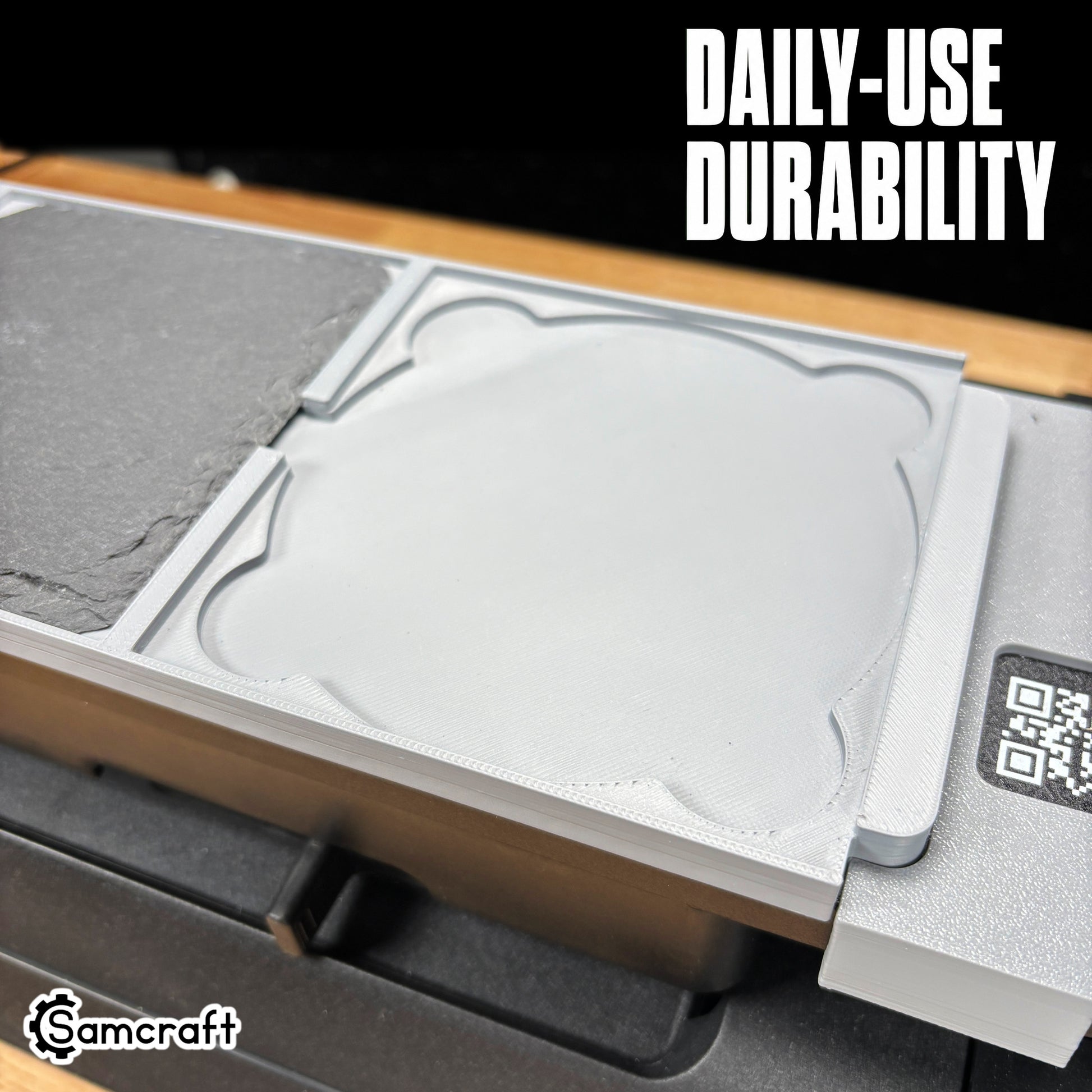 Close-up of the Samcraft 4-inch Drink Coaster Jig's durable gray tray with a recessed coaster pocket and built-in alignment ruler on the eufyMake E1.