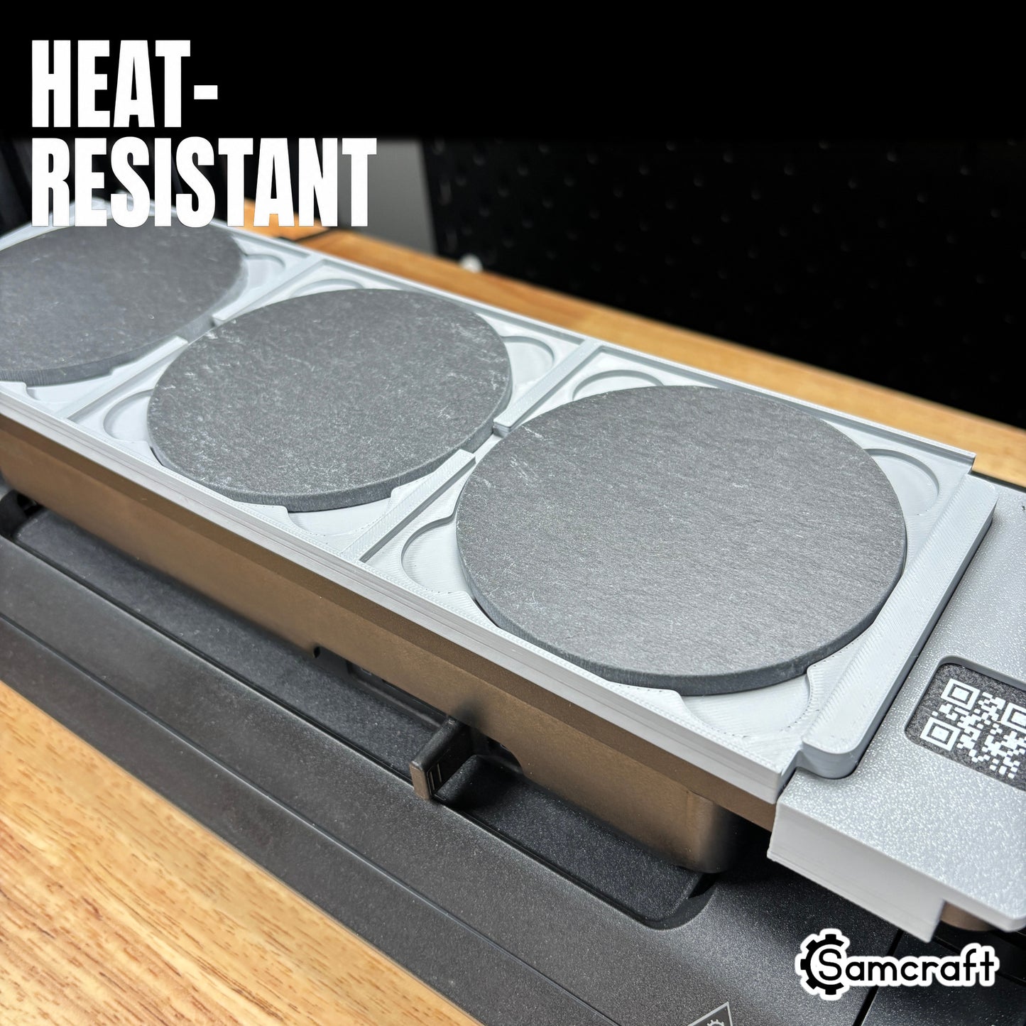 Heat-resistant Samcraft 4-inch Drink Coaster Jig holding round slate coasters in recessed pockets with built-in ruler on the eufyMake E1 UV printer.