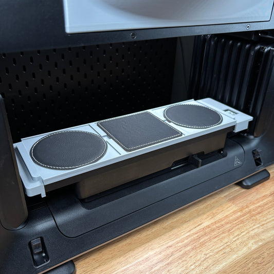 Samcraft 99mm drink coaster jig on the eufyMake E1 print bed, holding round dark leatherette coasters.