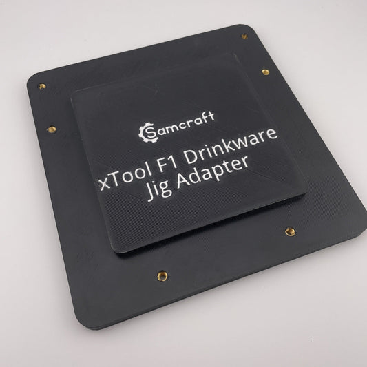 Samcraft xTool F1 drinkware jig adapter, a black base plate engraved with the product name.
